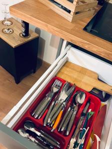 a drawer filled with utensils in a drawer at Chouett'studio in Dijon