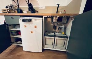 a small kitchen with a refrigerator and a stove at Chouett'studio in Dijon +11 photos