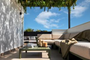 a living room with a couch and a table at Zea Urban Living in Piraeus