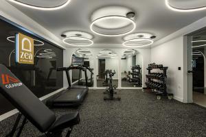 a gym with treadmills and ellipticals in a room at Zea Urban Living in Piraeus