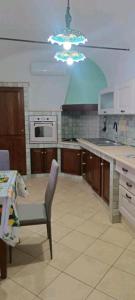a kitchen with a table and a chair in it at Nerissa apartments in Terrasini