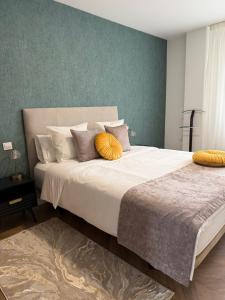 a bedroom with a large bed with yellow pillows at La CASA ROJA SOLARES in Solares