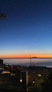 a view of a city at night with the horizon at Villa Fiore in Vico Equense +56 photos