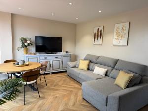 a living room with a couch and a table at La CASA ROJA SOLARES in Solares