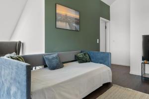 a couch with two pillows on it in a living room at Loftbude in Hürth