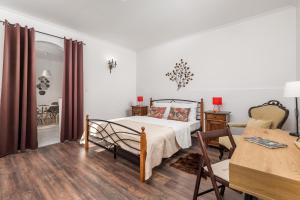 a bedroom with a bed and a chair and a table at Apartments Carmen in Matulji