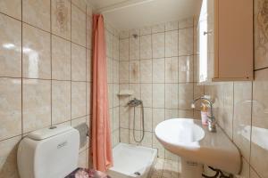 a small bathroom with a toilet and a sink at House Klimataria Kamilari in Kamilari +45 photos