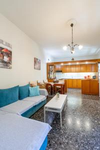 a living room with a couch and a table at House Klimataria Kamilari in Kamilari