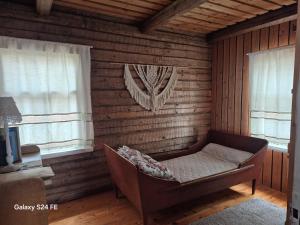 a room with a bed and two windows at Erämökki Puruveden rannalla in Vaara