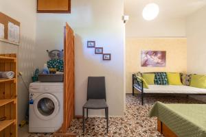 a room with a washing machine and a bed at House Klimataria Kamilari in Kamilari