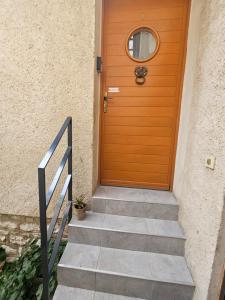a wooden door with a stairs leading into a house at Charmant studio in Vernon