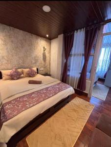 a bedroom with a large bed and a window at The Boho Darjeeling Stays in Darjeeling