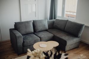 a living room with a couch and a table at Mazurska przystań in Ryn