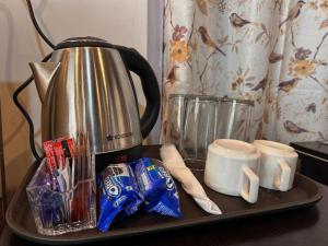 a tea kettle on a tray on a kitchen counter at The Boho Darjeeling Stays in Darjeeling