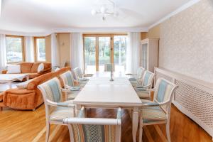 a dining room with a table and chairs at Villa Cetatuia in Cluj-Napoca
