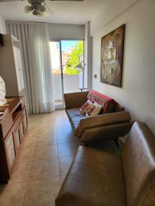 a living room with a couch and a table at Miramar in Miramar