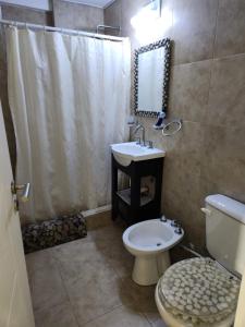 a bathroom with a toilet and a sink and a shower at Miramar in Miramar