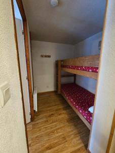 a small room with two bunk beds in it at DFJ des Neiges, Piscine, Pieds des pistes in Chamrousse +5 photos
