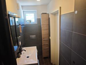 a small bathroom with a sink and a mirror at Apartmaji pr'Muranček in Radovljica +10 photos