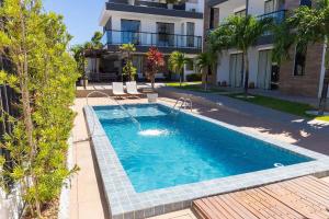 a swimming pool in front of a house at Altos do Caju - Triplex in Pirangi 300 meters from the World's Largest Cashew Tree by Carpediem in Parnamirim