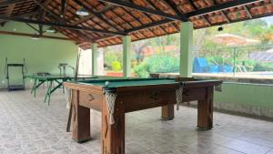 a pool table in the middle of a room at Vila Francesa Hotel in Penedo