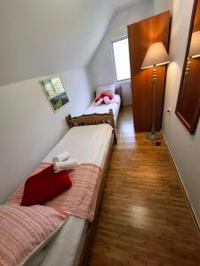 two beds in a small room with a lamp at TARA RIVER HOUSE in Odžića Glavica