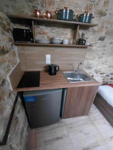 a small kitchen with a sink in a room at lefkara stone nest in Pano Lefkara