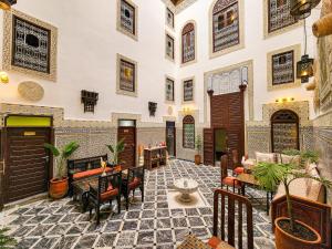 a courtyard with tables and chairs in a building at Riad Dar Mazaj Fes in Fez
