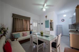 a kitchen and living room with a table and a couch at Vida House in Borsh