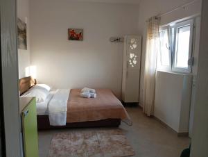 a bedroom with a bed with two towels on it at Apartment Deki studio 2 in Kotor
