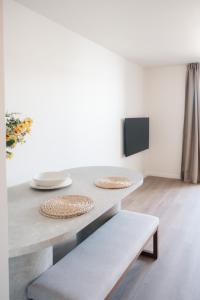 a dining room table with two plates and two benches at Luxurious Suite - Train Station Deinze in Deinze