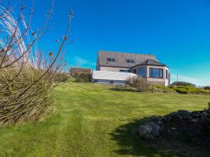 a house on top of a grassy field at Vestley Banks in Orkney