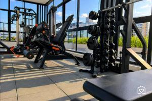a gym with a view of a city in the background at Edifício MOVE Novo- Tambaú in João Pessoa