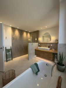 a large bathroom with a tub and a sink at WaldQuartier in Memmelsdorf +30 photos