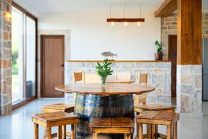 a dining room with a wooden table and chairs at Vržina Farm House Skadar Lake in Virpazar