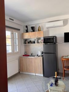 a kitchen with a black refrigerator and a table at SeaBreeze Milos in Mytakas +7 photos