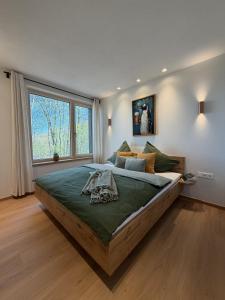 a large bed in a bedroom with a large window at WaldQuartier in Memmelsdorf