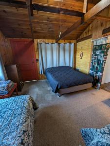 a bedroom with two beds in a room with wooden ceilings at 2BR 1BA Cabin #8 at Riverside Point Resort in Park Rapids