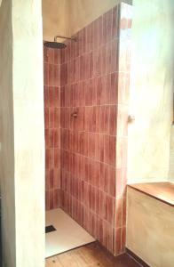 a bathroom with a shower with brown tile at Rosie's Garden in Bocairent