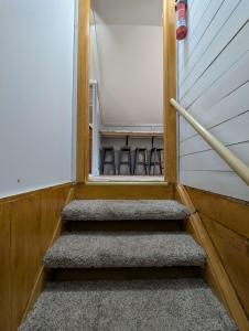 a set of stairs in a room with chairs at Studio Loft #9 at Riverside Point Resort in Park Rapids