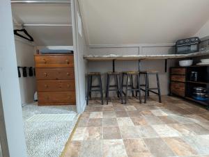 a kitchen with two bar stools and a counter in a room at Studio Loft #9 at Riverside Point Resort in Park Rapids +26 photos