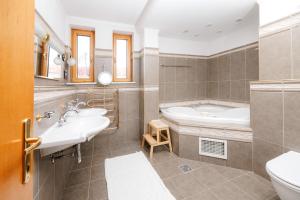 a bathroom with two sinks and a tub and a toilet at Villa Cetatuia in Cluj-Napoca +35 photos