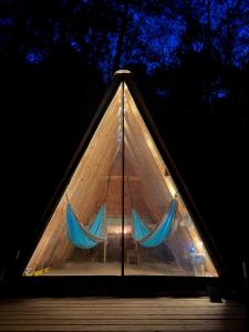 a pyramidangularangular window with blue curtains in it at The Outside Inn in Cullowhee