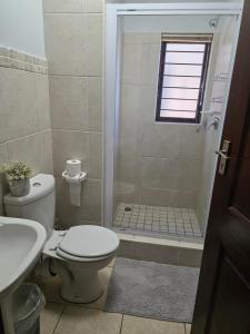 a bathroom with a toilet and a walk in shower at 15 Surabaya in Margate +3 photos