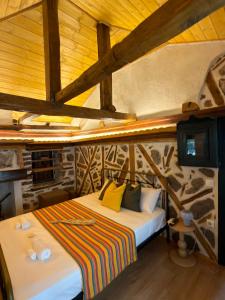 a bedroom with a bed in a room with wooden ceilings at Atelies View House in Potamiá