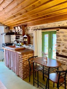 a kitchen with a table and chairs and a counter at Atelies View House in Potamiá