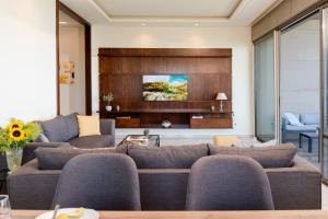 a living room with a couch and a tv at Brummana Views in Broummana