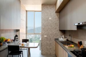 a kitchen with a counter and a table with chairs at Brummana Views in Broummana