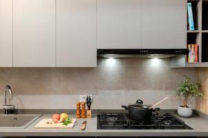 a kitchen with white cabinets and a pot on a stove at Brummana Views in Broummana +10 photos