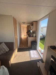a small living room with a couch and a kitchen at S-M Statics in Kinmel Bay